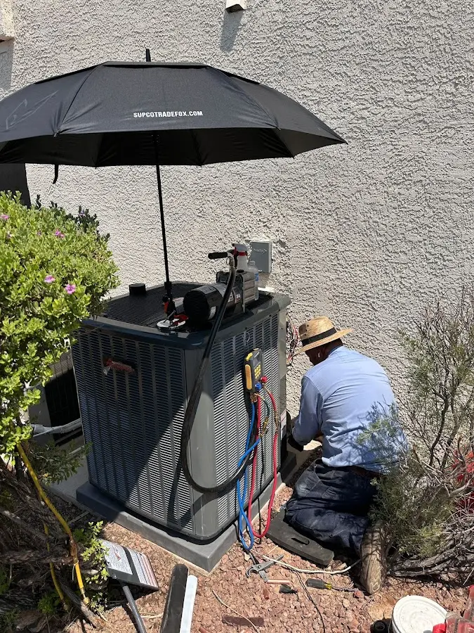 HVAC technician performing outdoor AC maintenance in Chocolay